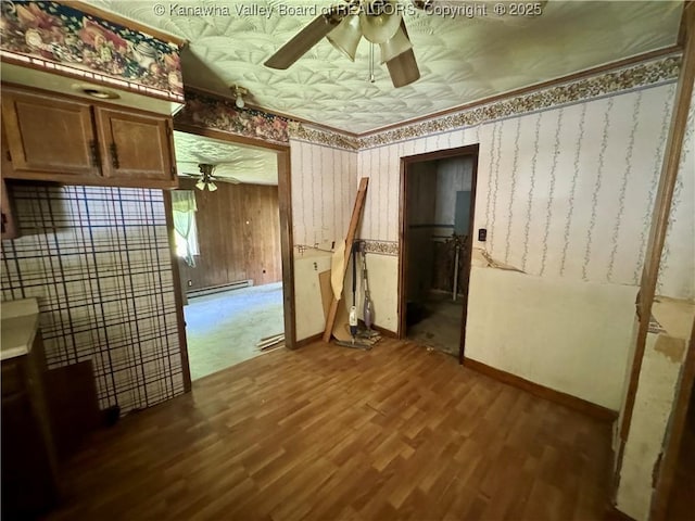 391 Mckinley St, Wharton, WV 25208 - empty room featuring ceiling fan, dark wood finished floors, an ornate ceiling, and baseboards