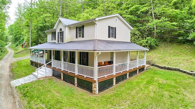 106 Coon Hollow Rd, Charleston, WV 25312 - view of front of home featuring a porch, metal roof, a front yard, and a wooded view