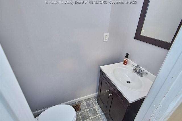 106 Coon Hollow Rd, Charleston, WV 25312 - bathroom featuring vanity, baseboards, and toilet