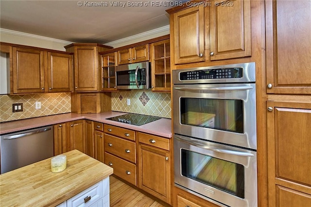 106 Coon Hollow Rd, Charleston, WV 25312 - kitchen featuring stainless steel appliances, crown molding, brown cabinetry, wood counters, and decorative backsplash