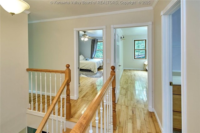 106 Coon Hollow Rd, Charleston, WV 25312 - hall featuring an upstairs landing, wood-type flooring, ornamental molding, and baseboards
