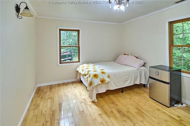 106 Coon Hollow Rd, Charleston, WV 25312 - bedroom featuring light wood finished floors, baseboards, crown molding, freestanding refrigerator, and a chandelier