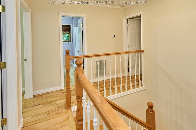 106 Coon Hollow Rd, Charleston, WV 25312 - corridor featuring an upstairs landing, wood finished floors, ornamental molding, and baseboards