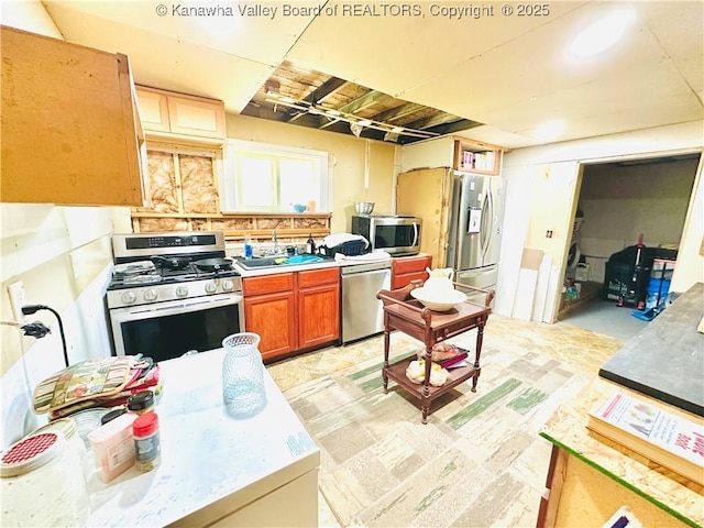 15047 Charleston Rd, Kenna, WV 25248 - kitchen with appliances with stainless steel finishes, a sink, brown cabinetry, and light countertops