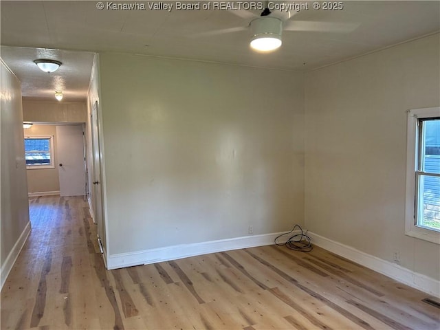 1005 E St, South Charleston, WV 25303 - spare room with wood finished floors, baseboards, a ceiling fan, and healthy amount of natural light