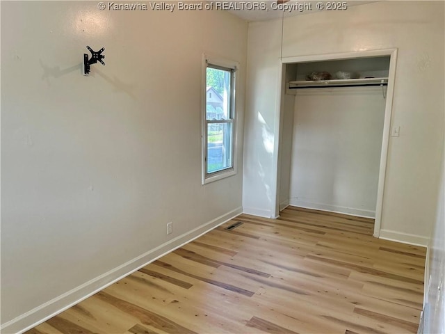 1005 E St, South Charleston, WV 25303 - unfurnished bedroom with wood finished floors, baseboards, and a closet