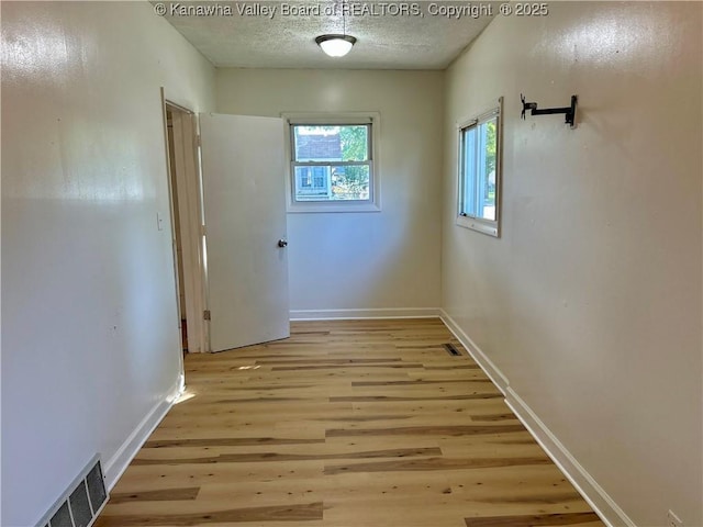 1005 E St, South Charleston, WV 25303 - corridor featuring light wood-style flooring, baseboards, and a textured ceiling