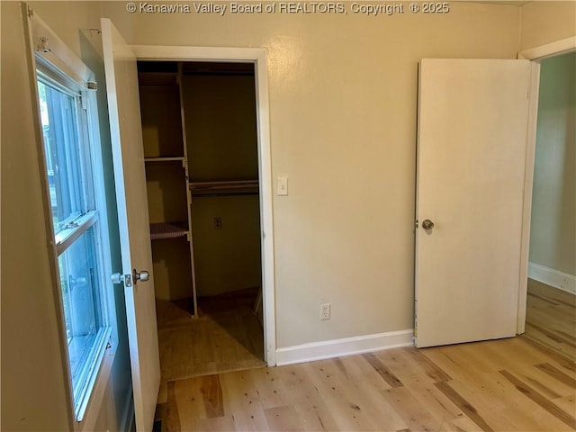 1005 E St, South Charleston, WV 25303 - unfurnished bedroom with light wood-style flooring, a closet, and baseboards
