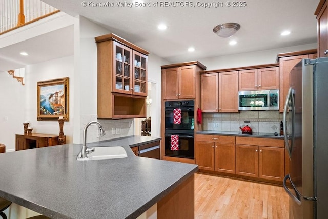 16 Pinnacle Dr, Charleston, WV 25311 - kitchen featuring appliances with stainless steel finishes, a sink, a peninsula, dark countertops, and tasteful backsplash