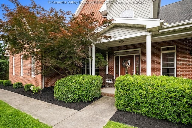 16 Pinnacle Dr, Charleston, WV 25311 - doorway to property featuring a porch, brick siding, and a shingled roof