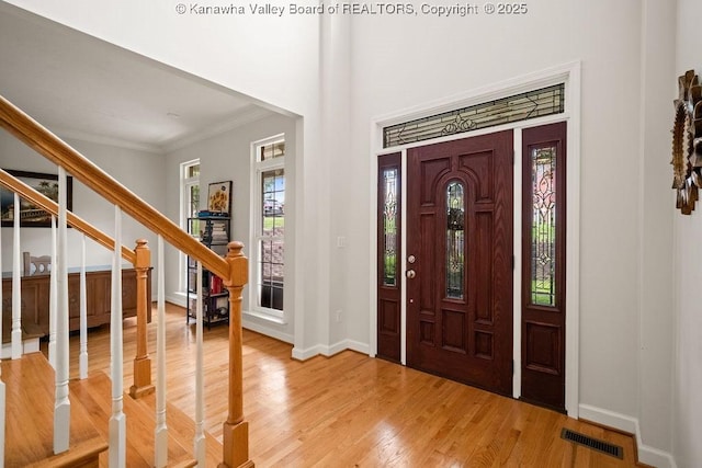 16 Pinnacle Dr, Charleston, WV 25311 - entryway featuring stairway, baseboards, light wood finished floors, and crown molding