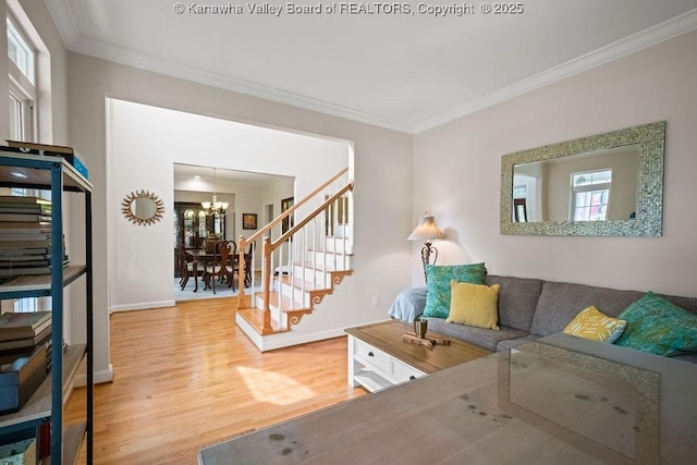 16 Pinnacle Dr, Charleston, WV 25311 - living room with a chandelier, light wood-style flooring, crown molding, stairs, and baseboards