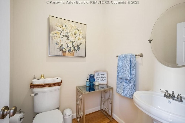 16 Pinnacle Dr, Charleston, WV 25311 - half bathroom with a sink, toilet, wood finished floors, and baseboards