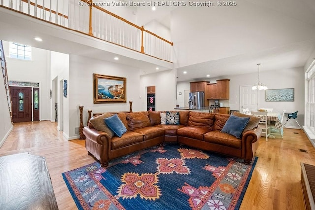 16 Pinnacle Dr, Charleston, WV 25311 - living area with a towering ceiling, a chandelier, light wood finished floors, baseboards, and recessed lighting
