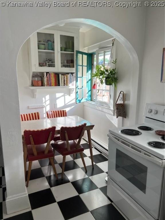 515 Maxwell St, Charleston, WV 25311 - kitchen featuring white range with electric cooktop, tile patterned floors, arched walkways, and glass insert cabinets