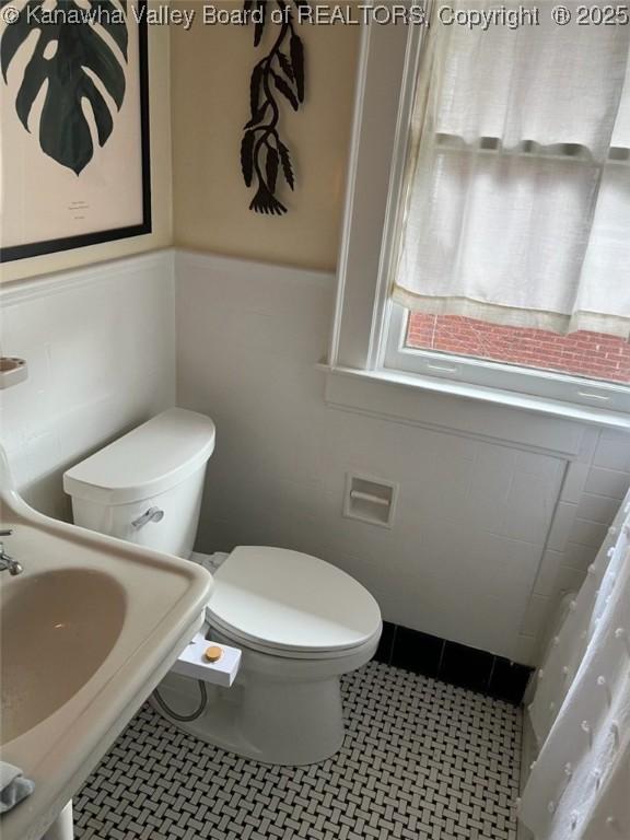515 Maxwell St, Charleston, WV 25311 - bathroom with toilet, a sink, and a wainscoted wall