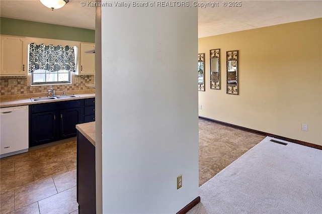 100 Timberlake Cir, Scott Depot, WV 25560 - kitchen featuring white dishwasher, a sink, backsplash, light countertops, and light tile patterned floors