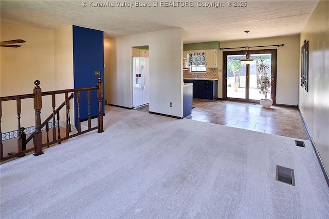 100 Timberlake Cir, Scott Depot, WV 25560 - empty room featuring light colored carpet, a textured ceiling, baseboards, and ceiling fan