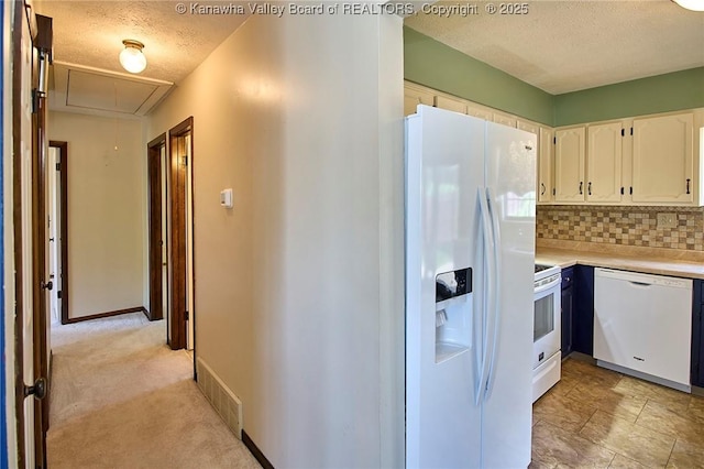 100 Timberlake Cir, Scott Depot, WV 25560 - kitchen with white appliances, a textured ceiling, light countertops, white cabinets, and tasteful backsplash