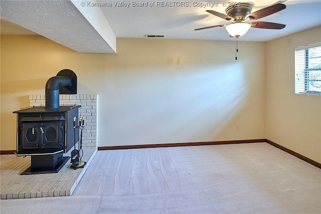100 Timberlake Cir, Scott Depot, WV 25560 - unfurnished living room featuring carpet floors, a wood stove, ceiling fan, and baseboards