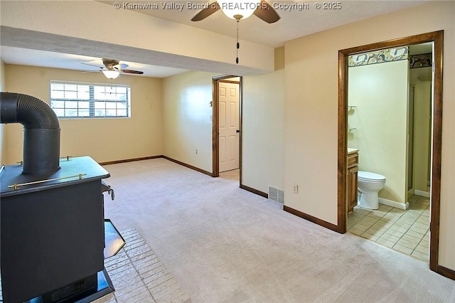 100 Timberlake Cir, Scott Depot, WV 25560 - carpeted living area featuring ceiling fan, baseboards, and a wood stove