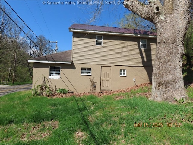 3321 Heizer Creek Rd, Poca, WV 25159 - view of property exterior featuring stucco siding, metal roof, and a lawn