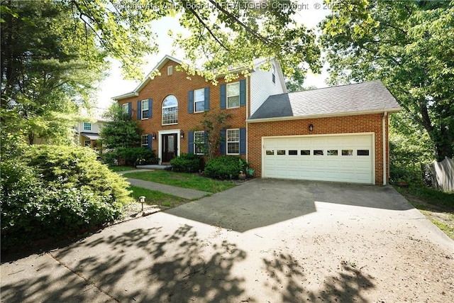9 Shamblin Pl, Charleston, WV 25314 - colonial-style house with concrete driveway, brick siding, and a garage