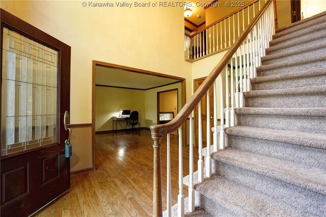 9 Shamblin Pl, Charleston, WV 25314 - foyer featuring wood finished floors, stairs, a high ceiling, and baseboards