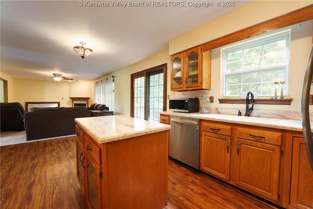 9 Shamblin Pl, Charleston, WV 25314 - kitchen with appliances with stainless steel finishes, a fireplace, plenty of natural light, and brown cabinetry