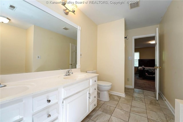 9 Shamblin Pl, Charleston, WV 25314 - ensuite bathroom with toilet, double vanity, marble finish flooring, and baseboards