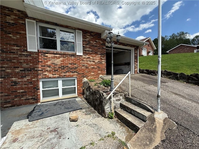 40 Hickory Ln, Madison, WV 25130 - view of side of home with brick siding, an attached garage, and concrete driveway
