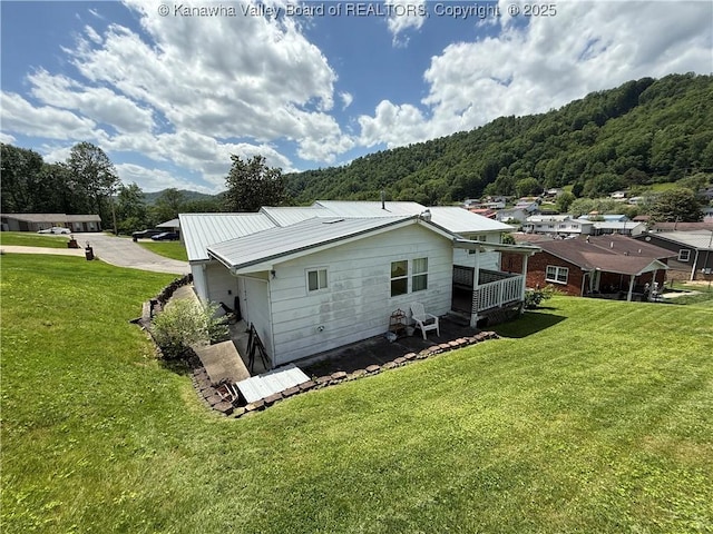 40 Hickory Ln, Madison, WV 25130 - rear view of house featuring a lawn, metal roof, and a view of trees