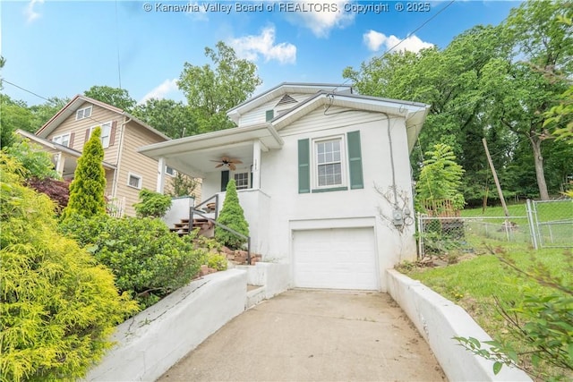 300 Forest Cir S, Charleston, WV 25303 - view of front of home featuring an attached garage, stucco siding, covered porch, concrete driveway, and a ceiling fan