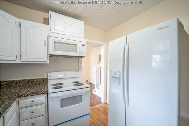 300 Forest Cir S, Charleston, WV 25303 - kitchen featuring white appliances, white cabinetry, light wood-style flooring, a textured ceiling, and dark stone counters