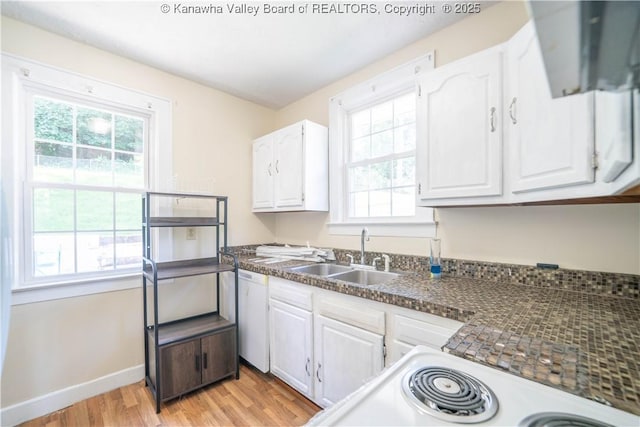 300 Forest Cir S, Charleston, WV 25303 - kitchen with light wood finished floors, healthy amount of natural light, white cabinetry, and dark countertops