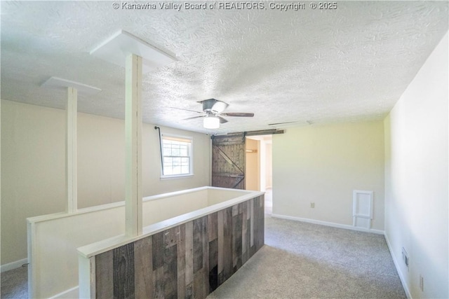 300 Forest Cir S, Charleston, WV 25303 - carpeted empty room featuring a barn door, ceiling fan, and a textured ceiling