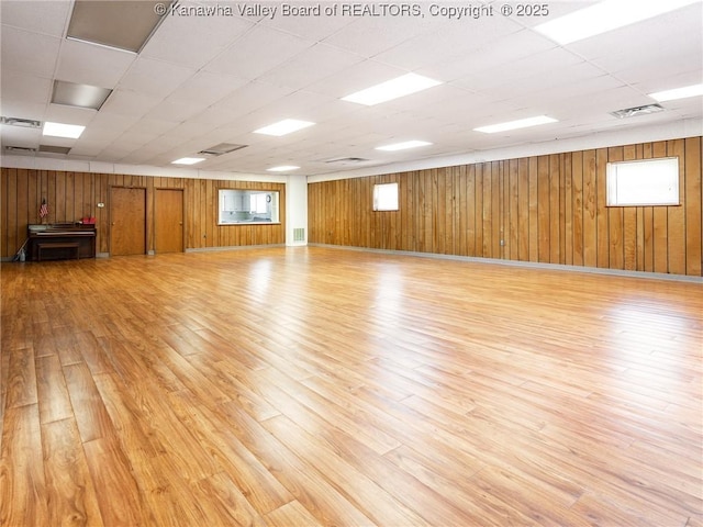 463 Gap View Dr, Charleston, WV 25326 - unfurnished room with light wood finished floors, wood walls, and a paneled ceiling