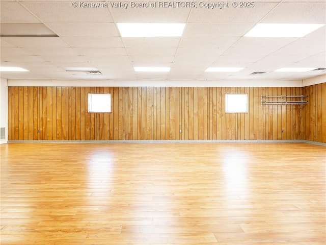 463 Gap View Dr, Charleston, WV 25326 - unfurnished room with wood finished floors, a drop ceiling, wooden walls, plenty of natural light, and baseboards
