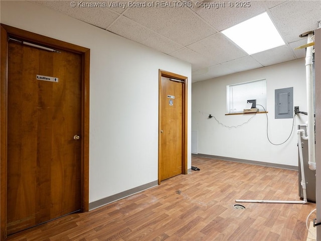 463 Gap View Dr, Charleston, WV 25326 - unfurnished room with electric panel, a paneled ceiling, wood finished floors, and baseboards