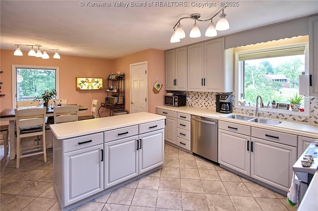 920 Gordon Dr Unit A, Charleston, WV 25303 - kitchen with stainless steel dishwasher, backsplash, a center island, rail lighting, and light countertops