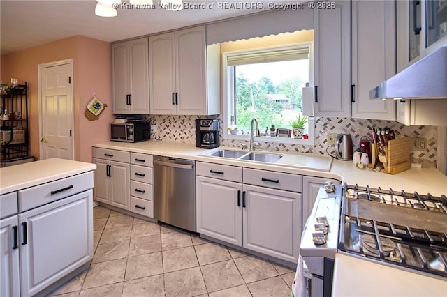 920 Gordon Dr Unit A, Charleston, WV 25303 - kitchen with stainless steel appliances, decorative backsplash, under cabinet range hood, light countertops, and light tile patterned floors