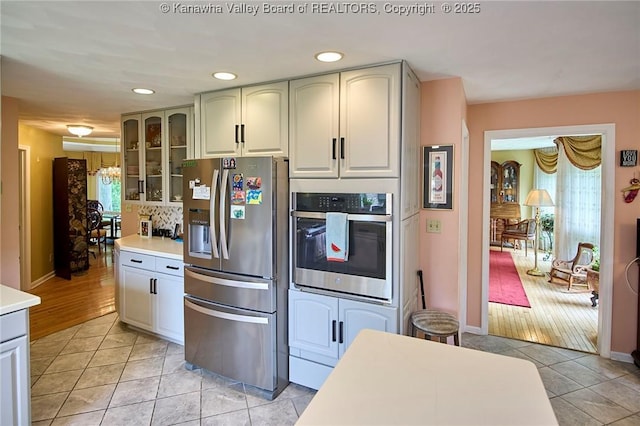 920 Gordon Dr Unit A, Charleston, WV 25303 - kitchen featuring stainless steel appliances, light tile patterned floors, glass insert cabinets, light countertops, and recessed lighting