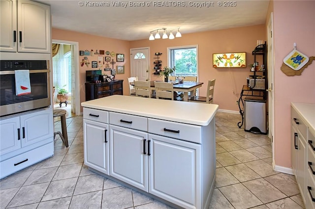 920 Gordon Dr Unit A, Charleston, WV 25303 - kitchen with oven, light tile patterned floors, light countertops, and a center island
