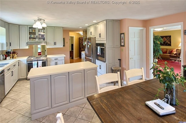 920 Gordon Dr Unit A, Charleston, WV 25303 - kitchen featuring appliances with stainless steel finishes, light countertops, light tile patterned floors, glass insert cabinets, and recessed lighting