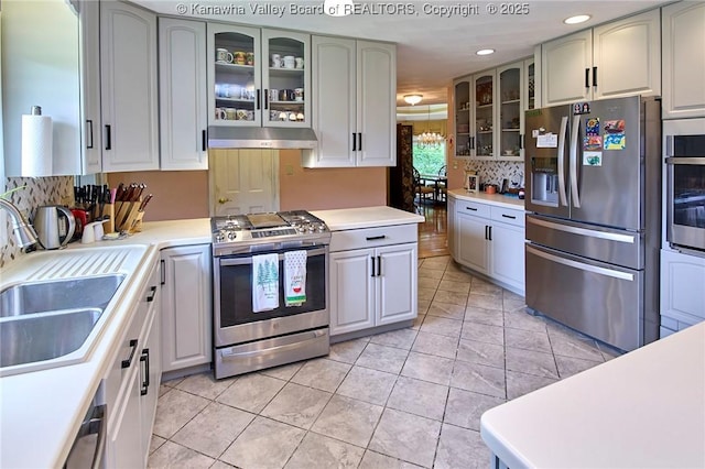 920 Gordon Dr Unit A, Charleston, WV 25303 - kitchen featuring appliances with stainless steel finishes, under cabinet range hood, recessed lighting, light countertops, and glass insert cabinets