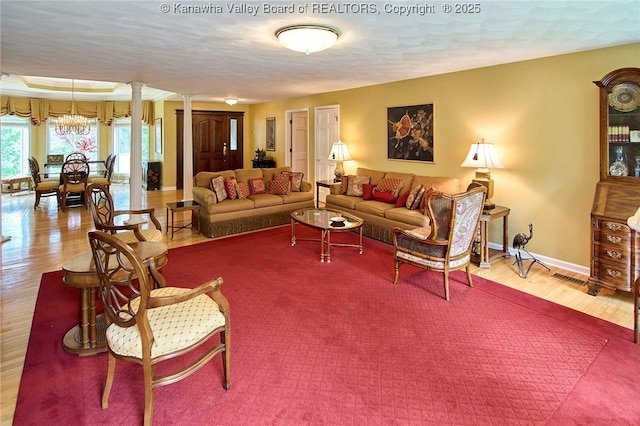 920 Gordon Dr Unit A, Charleston, WV 25303 - living room with ornate columns, wood finished floors, and a chandelier