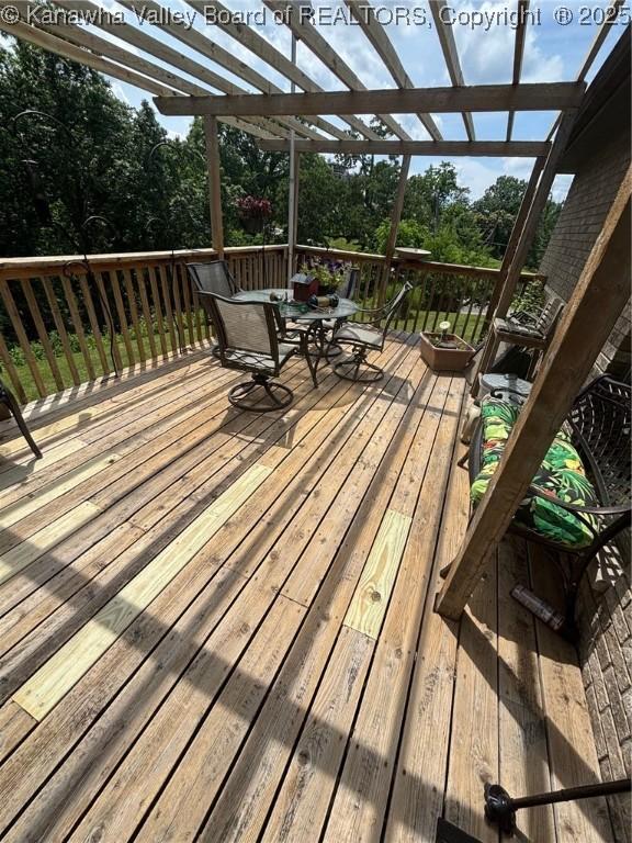 920 Gordon Dr Unit A, Charleston, WV 25303 - wooden deck featuring a pergola, outdoor dining area, and view of scattered trees