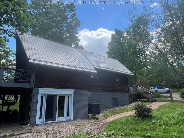 849 Random Rd, Ripley, WV 25271 - view of side of property with brick siding, a wooden deck, metal roof, central AC unit, and stairway