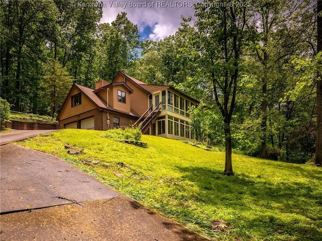 1799 Fishers Branch Rd, Charleston, WV 25312 - rustic home with a front lawn, a chimney, stairs, brick siding, and asphalt driveway