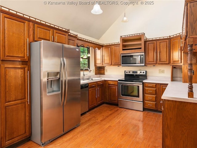 1799 Fishers Branch Rd, Charleston, WV 25312 - kitchen featuring stainless steel appliances, a sink, brown cabinetry, high vaulted ceiling, and light countertops